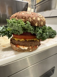 a burger sitting on top of a cutting board