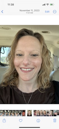 a woman is taking a selfie in a car