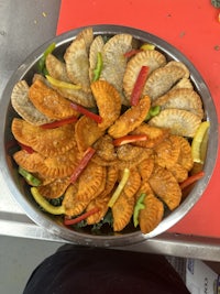 a plate full of stuffed pastries on a counter