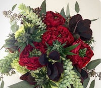 a bouquet of red and green flowers