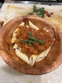 penne with tomato sauce on a wooden plate