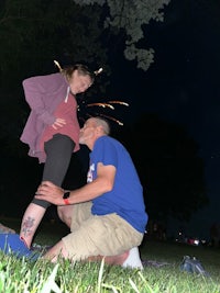 a man and a woman in a grassy area